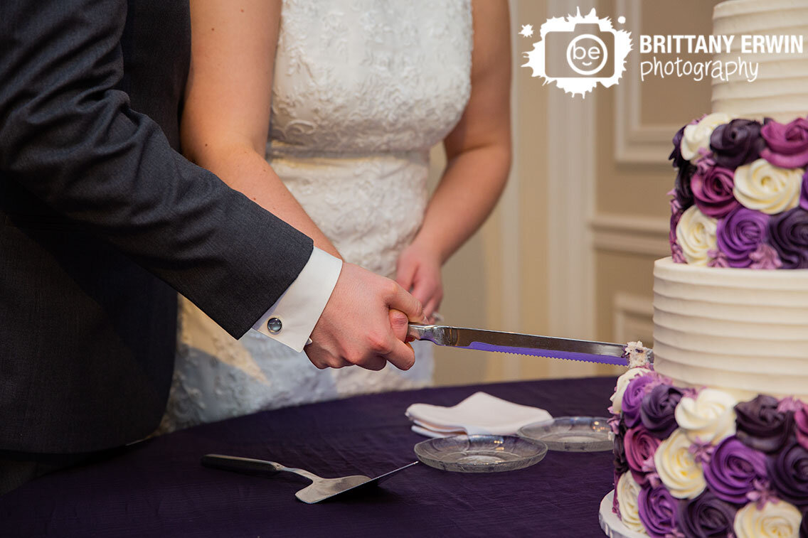 purple-ivory-and-lavender-rosette-buttercream-wedding-cake-cut-by-bride-and-groom.jpg
