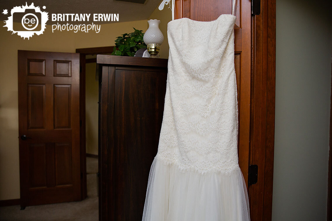 Wedding-dress-detail-photo-hanging-on-door.jpg