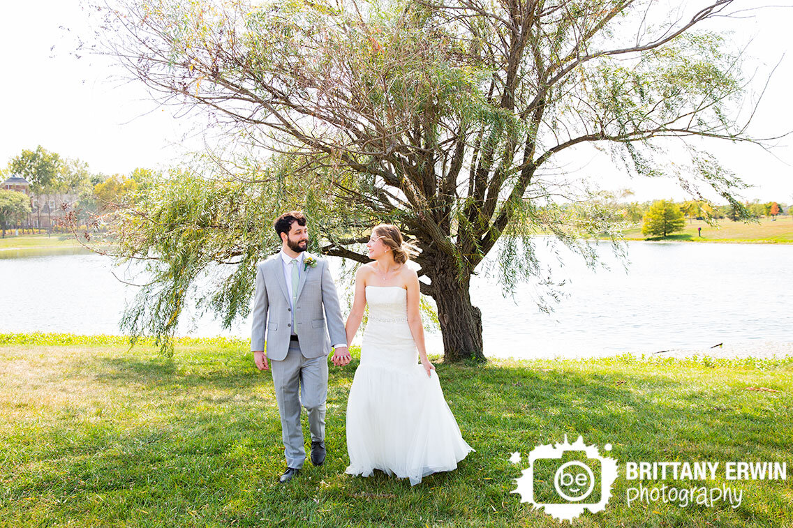 Indianapolis-wedding-photographer-Coxhall-Gardens-couple-walking-by-water-with-willow-tree.jpg