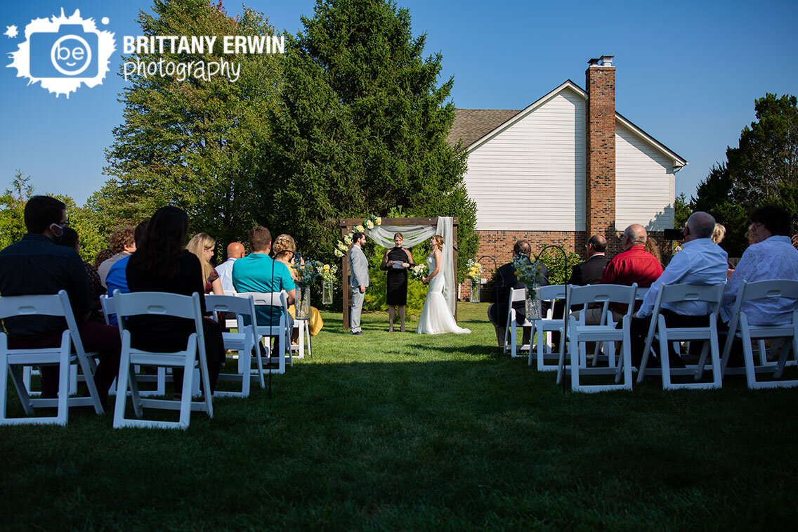 Outdoor-backyard-wedding-ceremony-photographer-couple-at-altar-fall.jpg