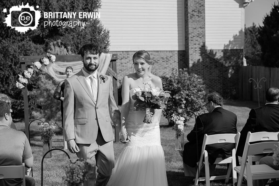 Backyard-wedding-ceremony-couple-announced-down-aisle.jpg