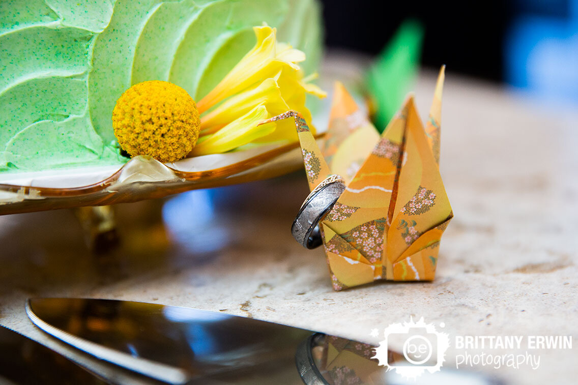 crane-origami-wedding-decoration-rings-on-head-by-cake.jpg