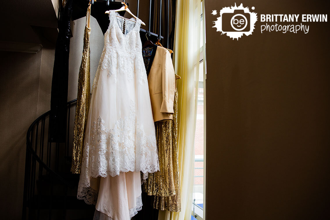 Indianapolis-wedding-photographer-bridal-gown-bridesmaid-dresses-suit-hanging-on-spiral-staircase.jpg
