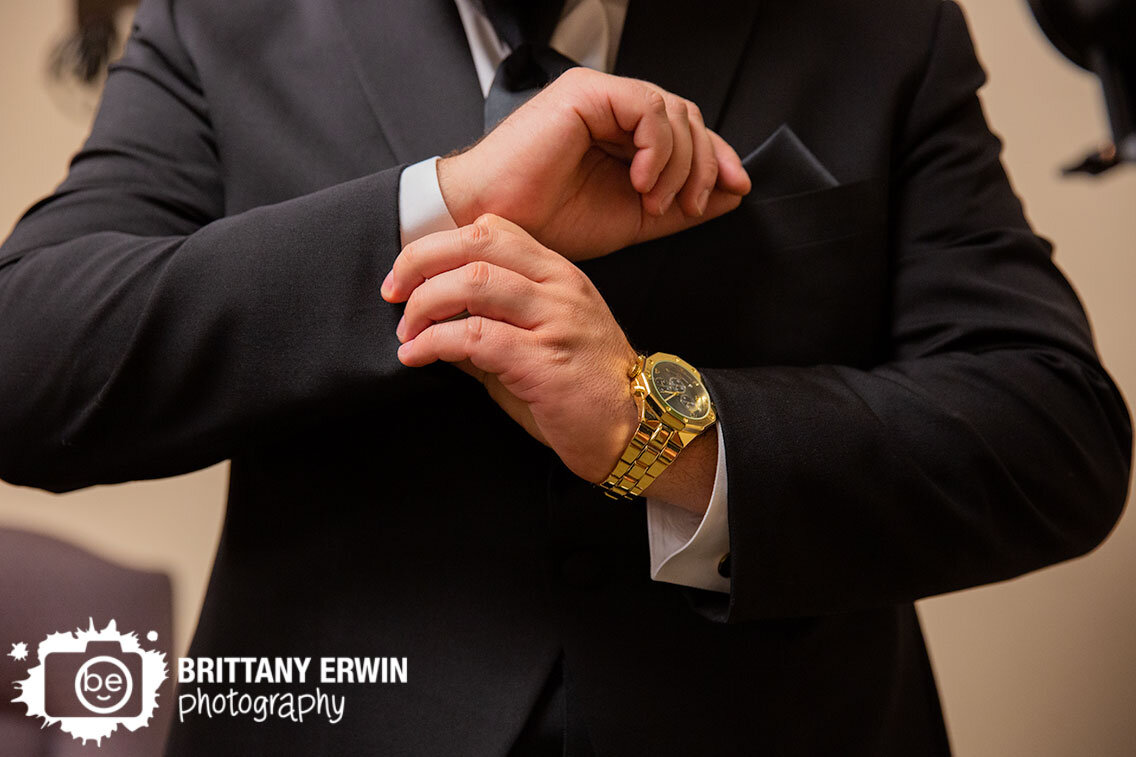 groom-straightening-cuff-links-gold-watch.jpg