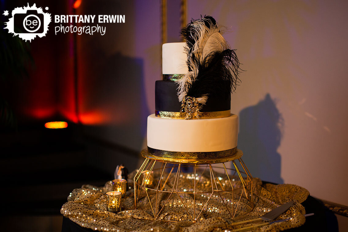 wedding-cake-with-feathers-gold-sequins-tablecloth.jpg