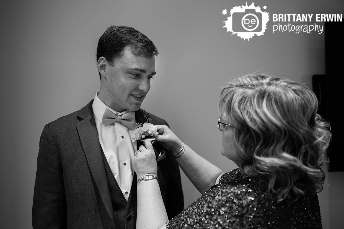 groom-getting-ready-mother-pinning-on-boutonniere-before-ceremony.jpg