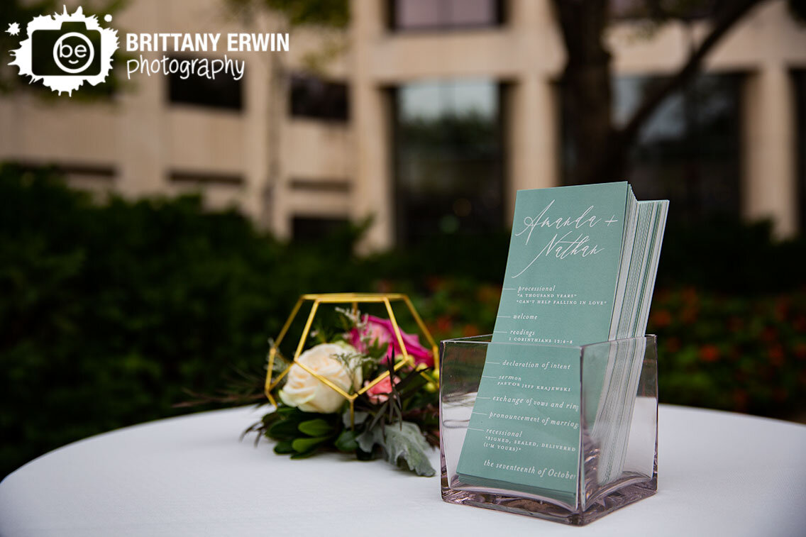 outdoor-wedding-ceremony-programs-at-table-with-floral-centerpiece.jpg