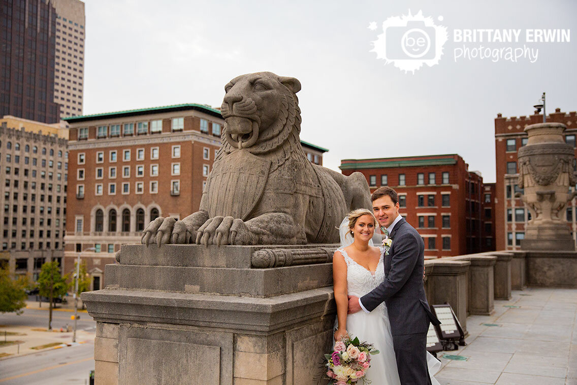 Downtown-Indianapolis-bridal-portrait-couple-on-Indiana-war-memorial-with-lion-sculpture.jpg