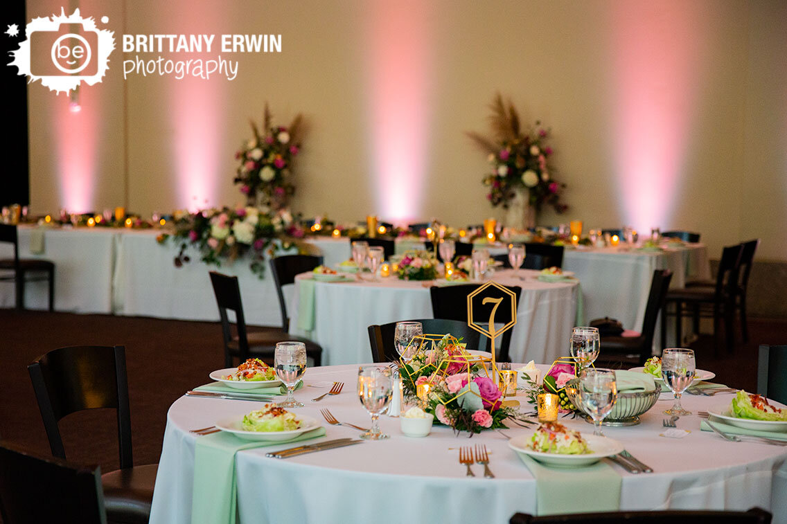 pink-uplighting-at-wedding-reception-gold-table-numbers.jpg