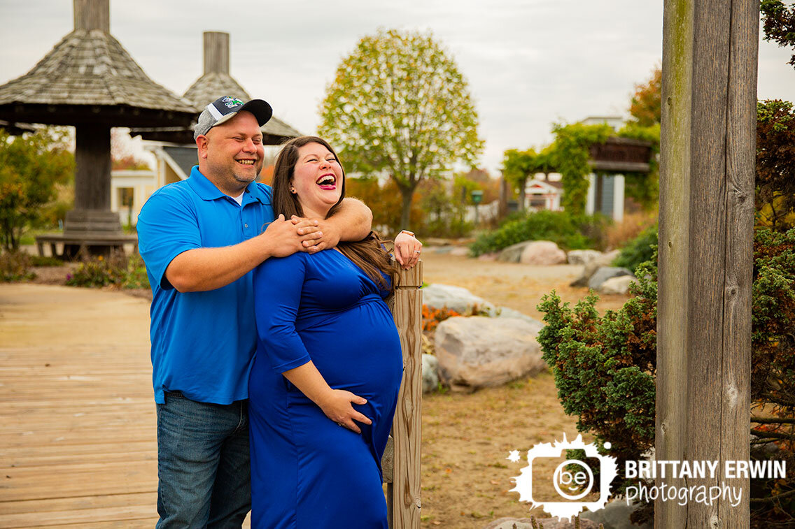 Indianapolis-maternity-portrait-photographer-couple-on-bridge-laughing-Coxhall-Gardens.jpg