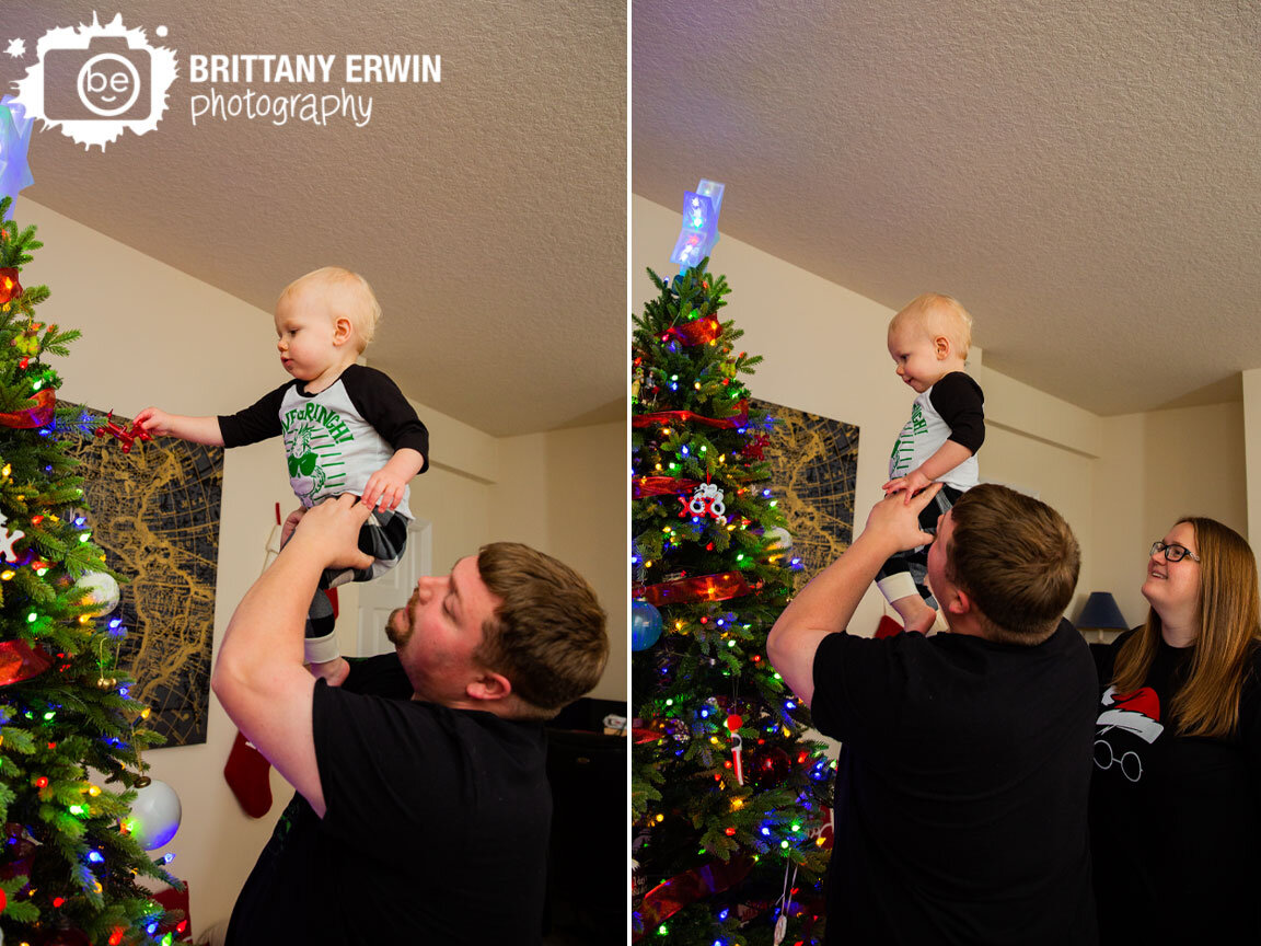 toddler-boy-picking-ornaments-on-tree-Christmas-portrait-photographer.jpg