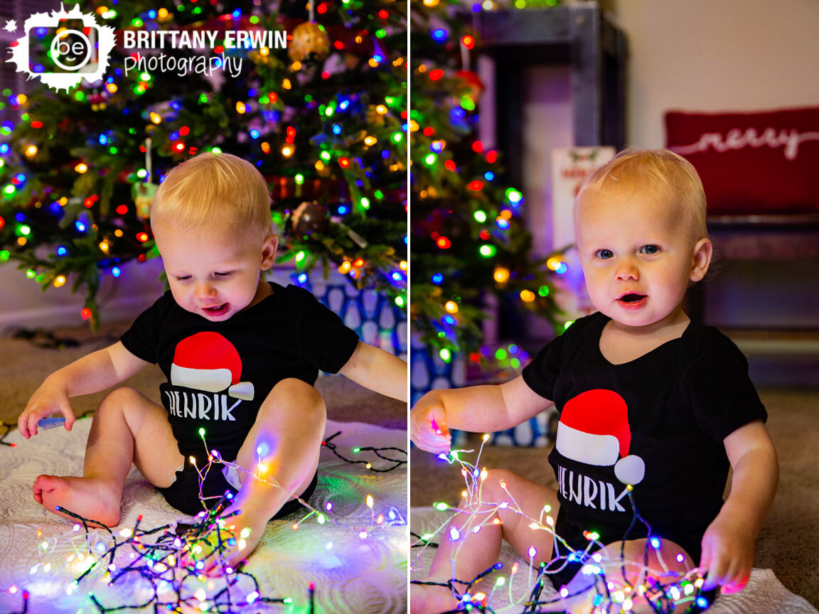 baby-boy-playing-with-christmas-lights-by-tree-custom-santa-hat-onesie.jpg