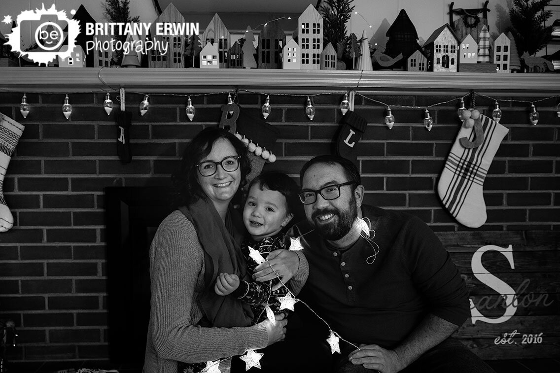 Indianapolis-in-home-lifestyle-christmas-portrait-session-family-at-fireplace-with-lights.jpg