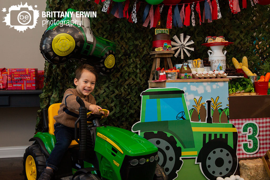 Indianapolis-portrait-photographer-in-home-tractor-theme-birthday-boy-riding-toy-rc-john-deere.jpg