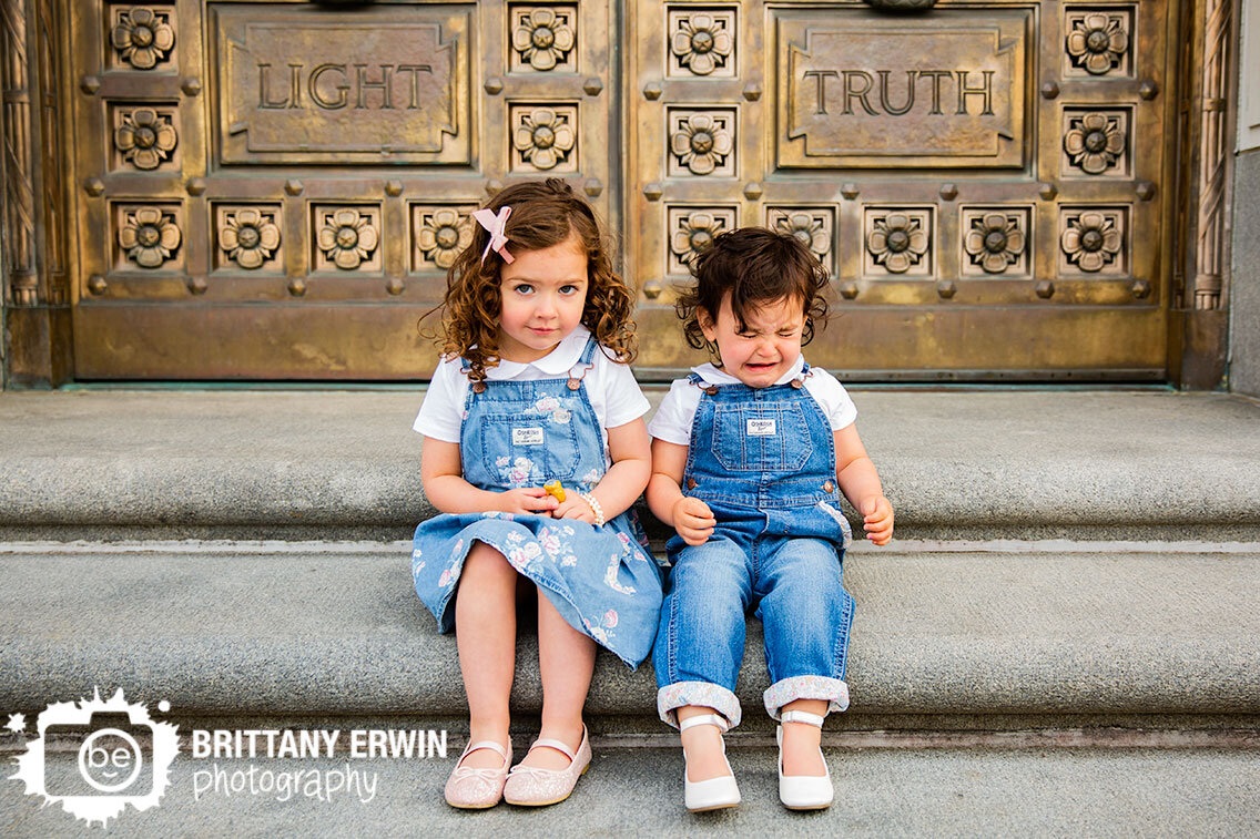 funny-siblings-portrait-girls-on-steps-gold-doors-light-truth.jpg