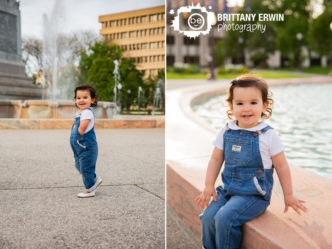 toddler-girl-silly-overalls-playing-at-fountain-downtown-Indianapolis-portrait-photographer.jpg