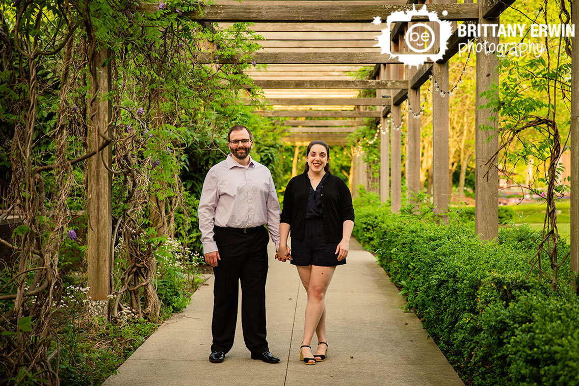 Indianapolis-Art-Center-couple-walking-through-vine-covered-path-in-Broad-Ripple.jpg
