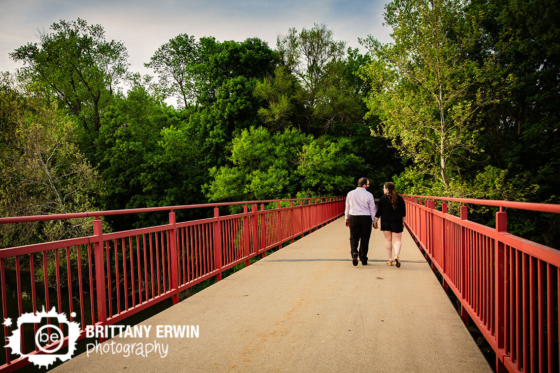 Indianapolis-monon-trail-red-bridge-couple-walking-into-trees.jpg