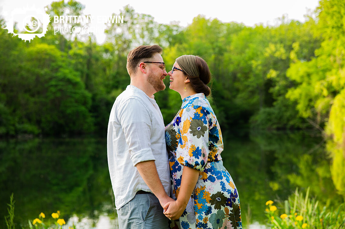 Indianapolis-engagement-portrait-photographer-couple-laughing-summer-by-pond-with-yellow-irises.jpg