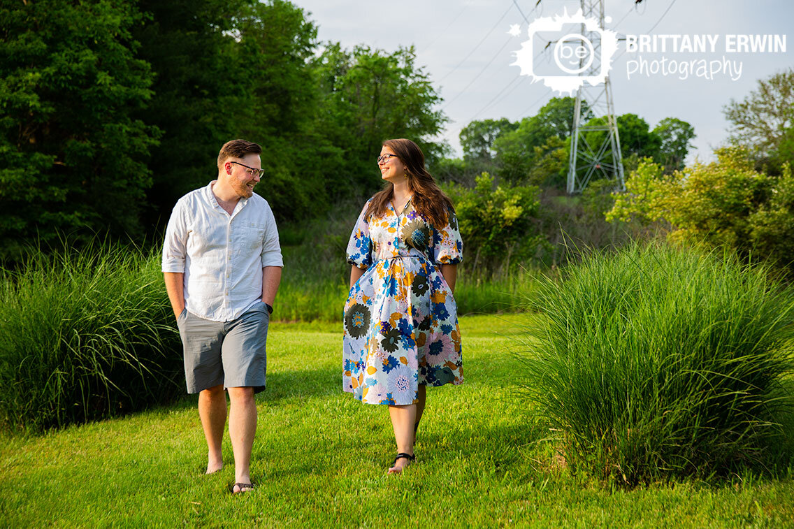 Indianapolis-engagement-photographer-summer-outdoor-flower-dress-couple-walking.jpg
