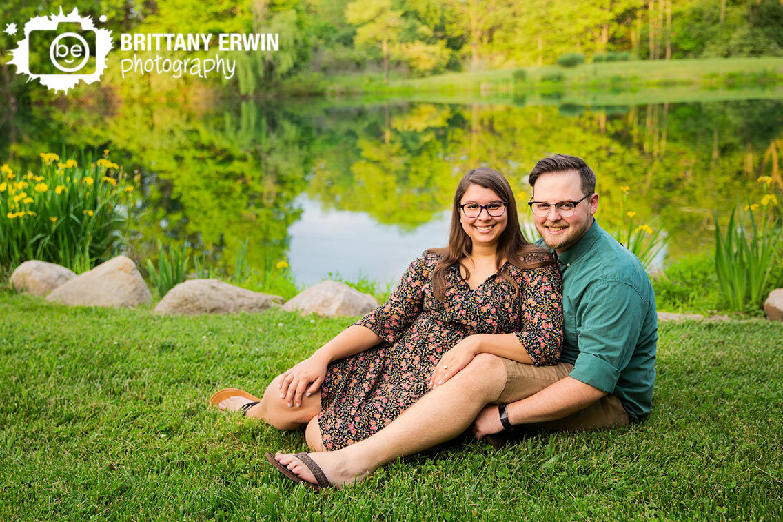Indianapolis-engagement-portrait-photographer-couple-by-pond-with-irises-in-bloom-reflection-on-water.jpg