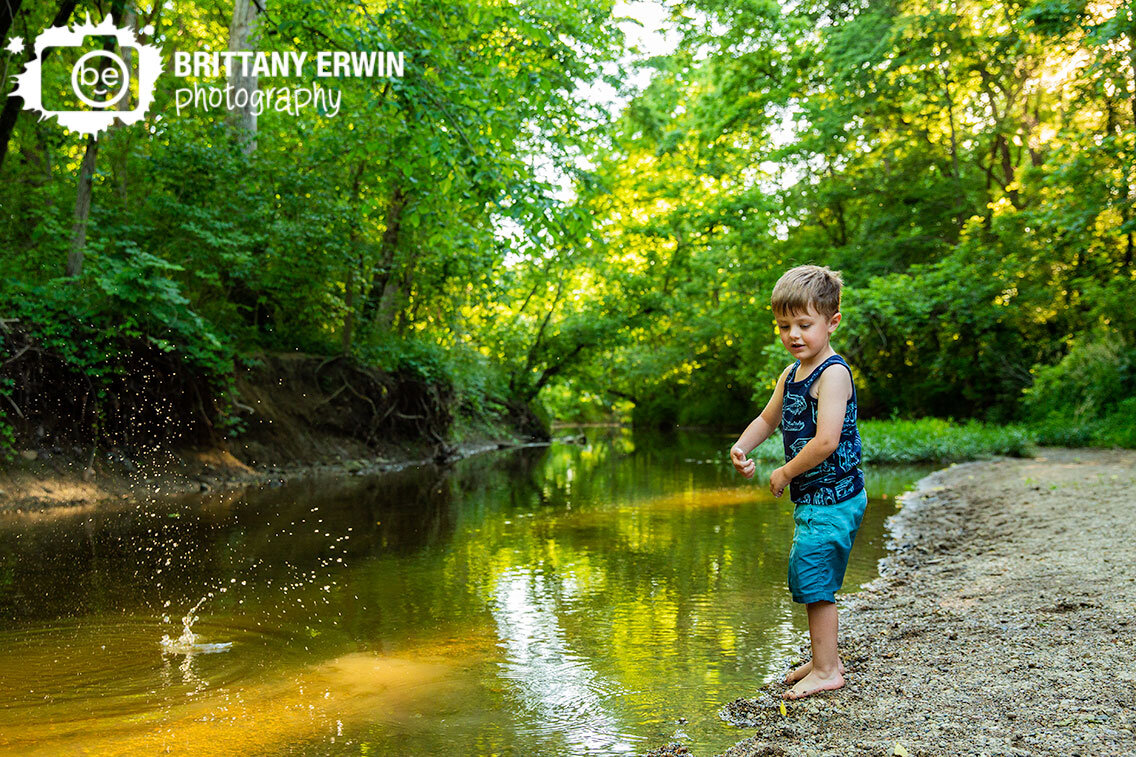 boy-throwing-rocks-into-water-birthday-portraits-creek-stomp-splash.jpg