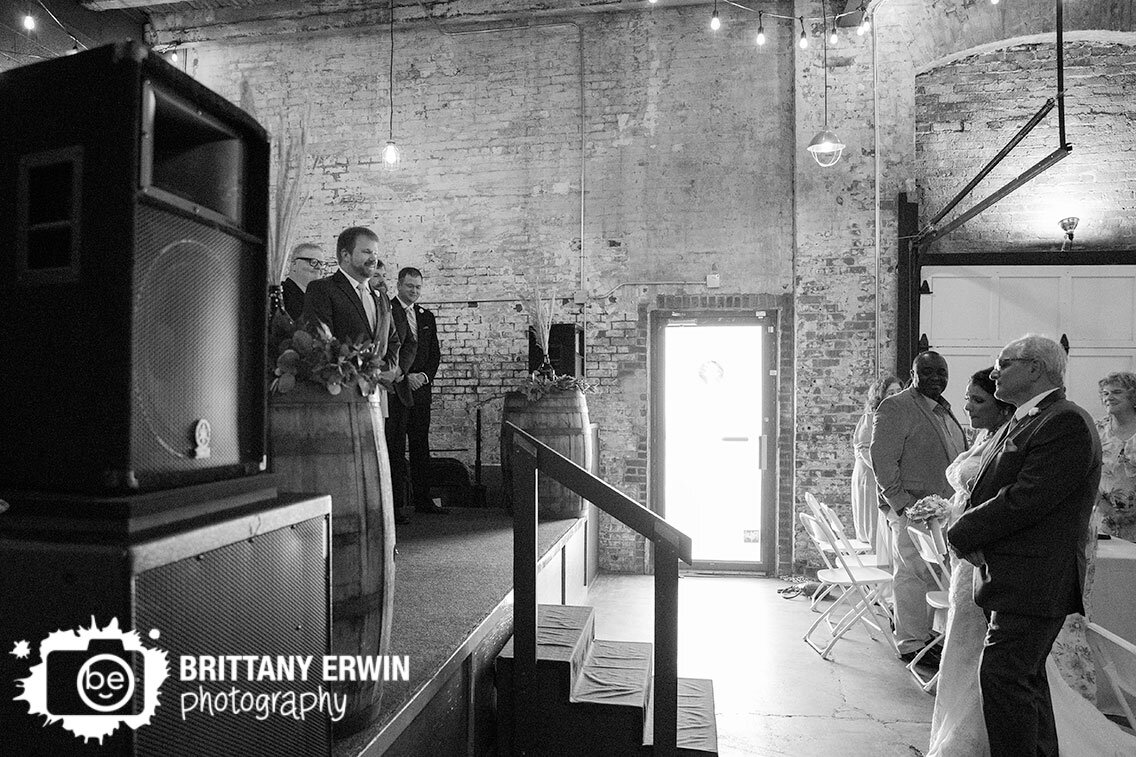 Indiana-wedding-ceremony-groom-on-stage-with-bride-walking-down-aisle.jpg