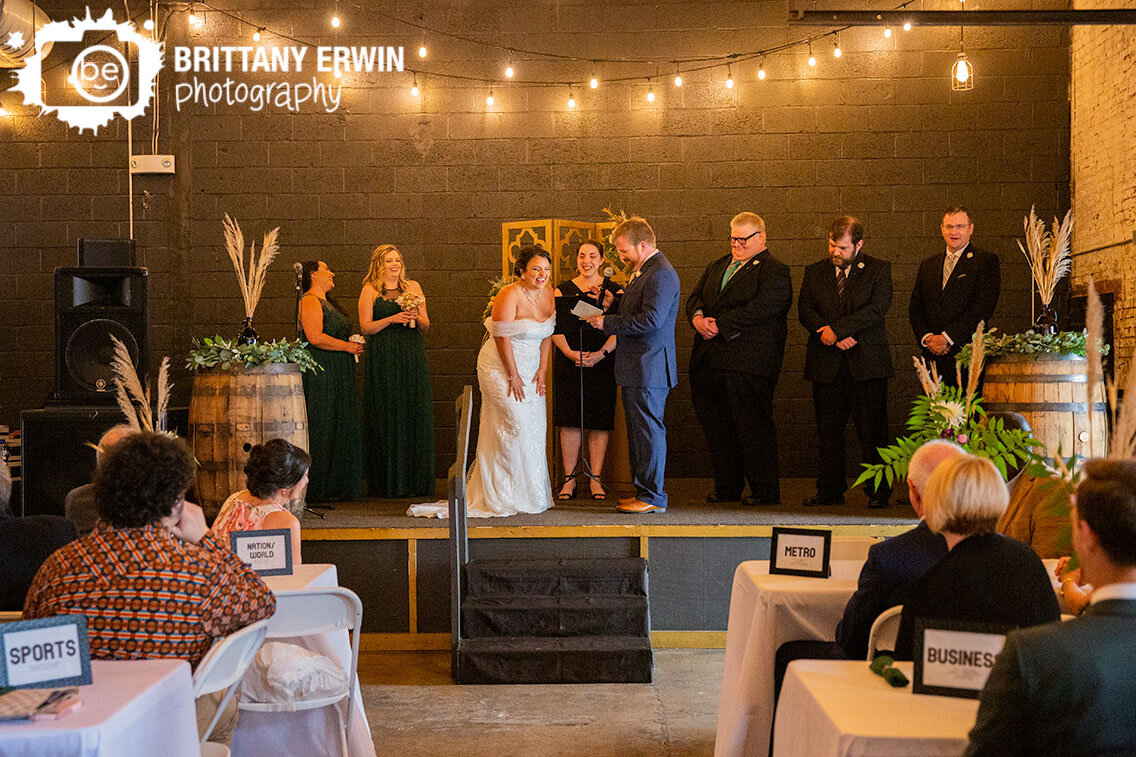 Indiana-City-Brewing-Company-wedding-ceremony-brewery-photographer-bride-reaction-groom-saying-vows.jpg