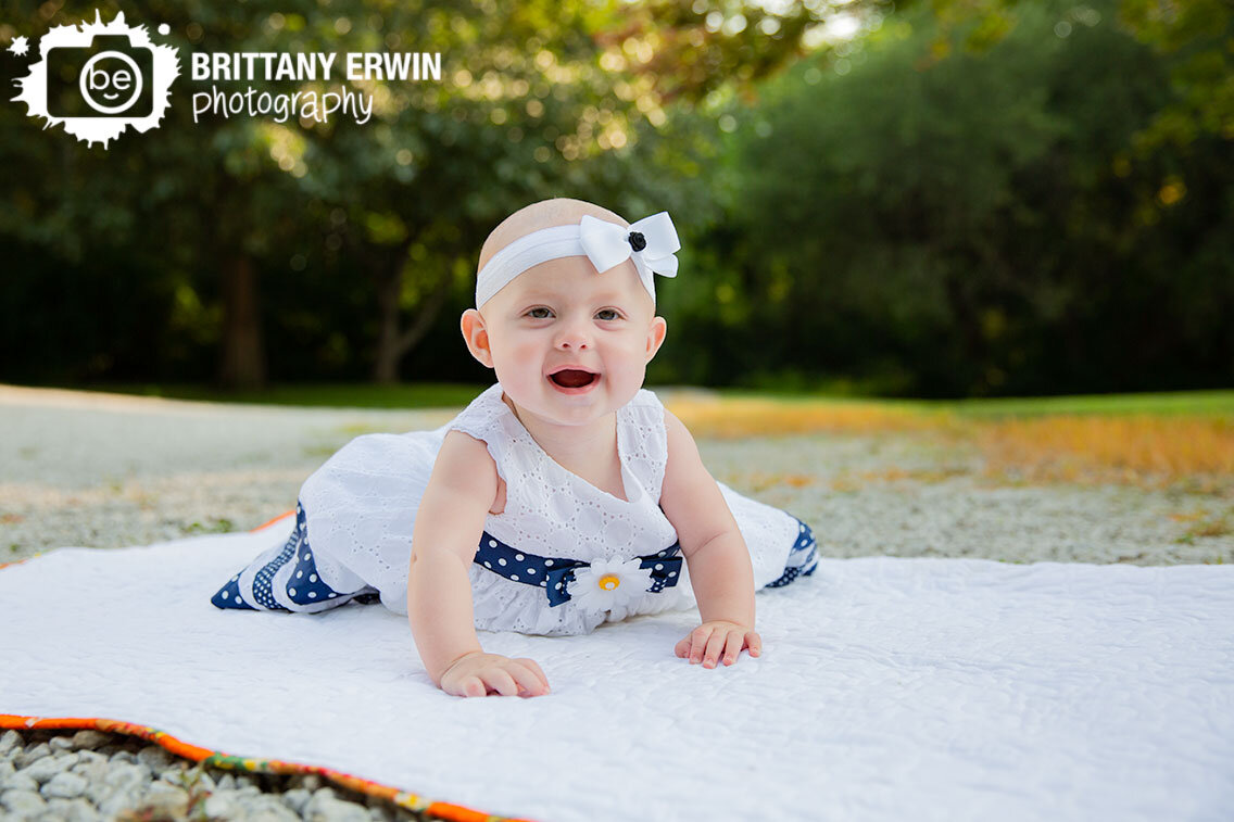baby-girl-milestone-portrait-photographer-white-dress-on-quilt.jpg
