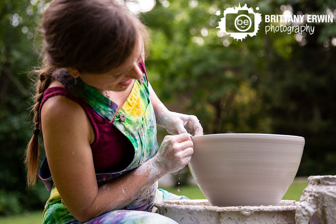 Ceramics-artist-throwing-large-bowl-on-potters-wheel-outside.jpg