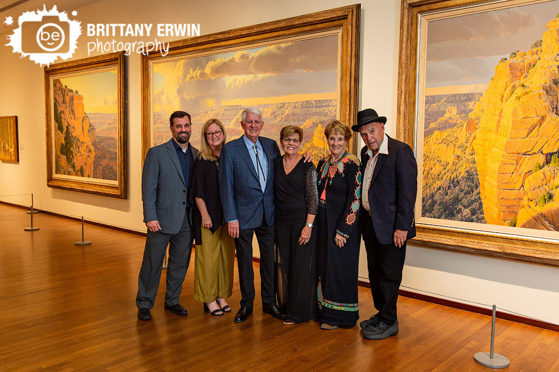 Quest-for-the-West-guests-pose-for-group-portrait-in-gallery-with-grand-canyon-tryptich-painting.jpg