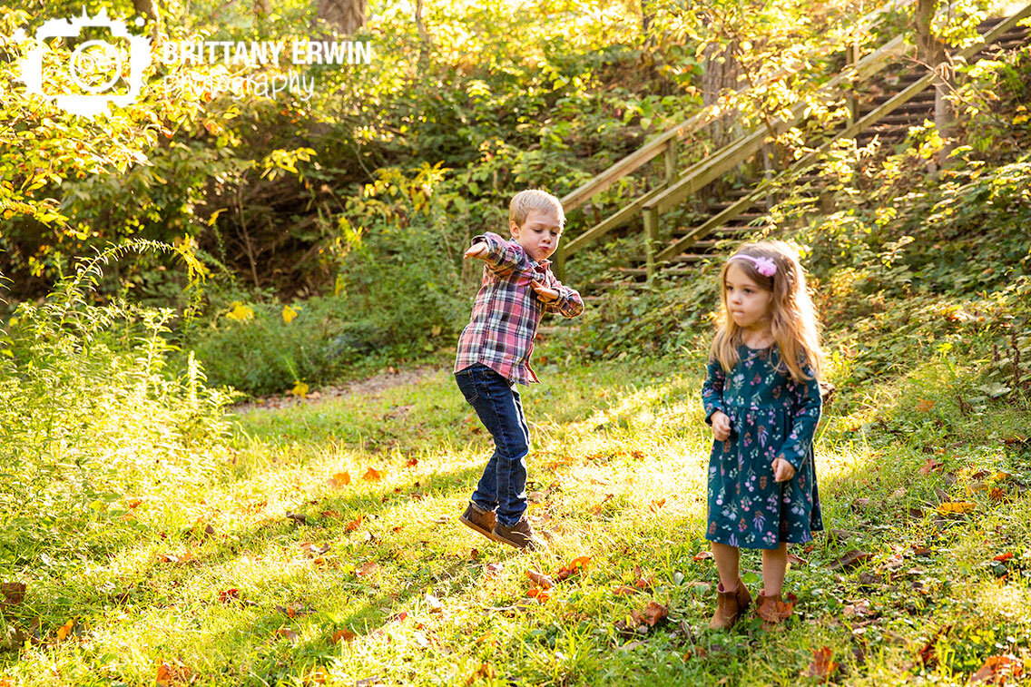 siblings-outside-playing-in-field-boy-silly-dancing.jpg
