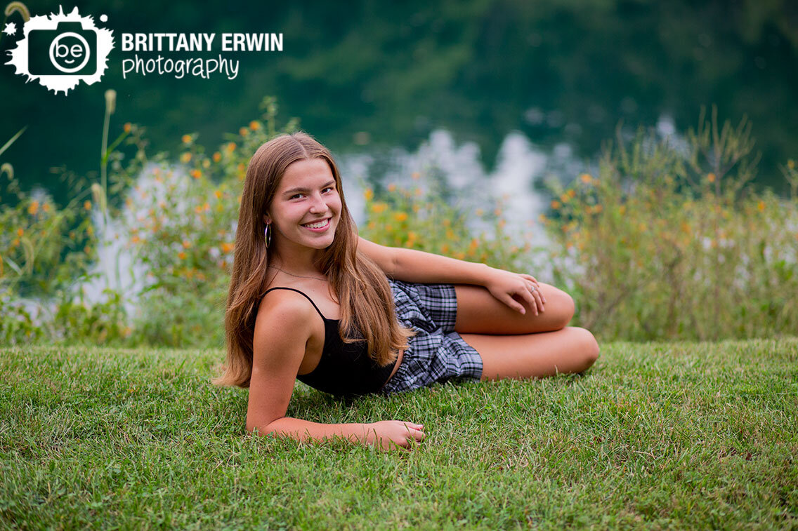 Indianapolis-high-school-senior-portrait-photographer-outside-next-to-pond-summer-wildflowers.jpg