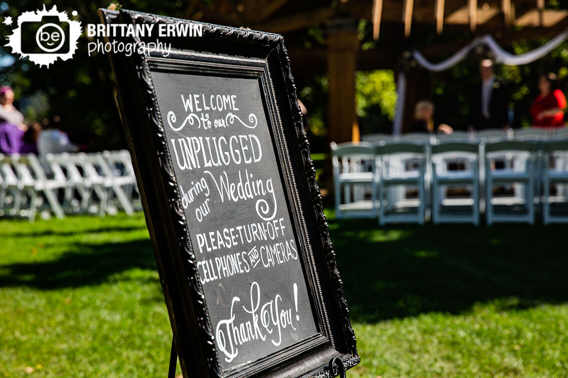 welcome-to-our-unplugged-wedding-sign-at-outdoor-ceremony.jpg