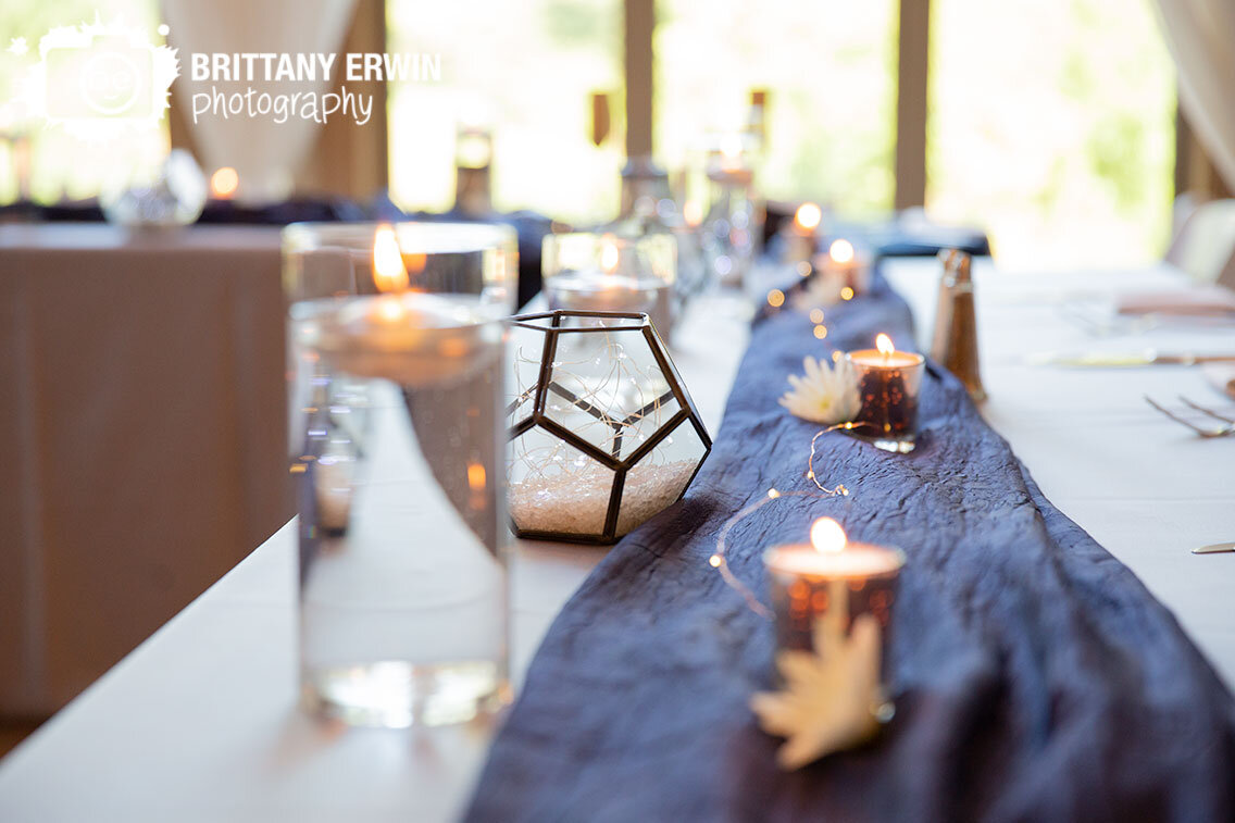 Indianapolis-wedding-photographer-candles-at-head-table-with-terarrium-filled-with-twinkle-lights.jpg