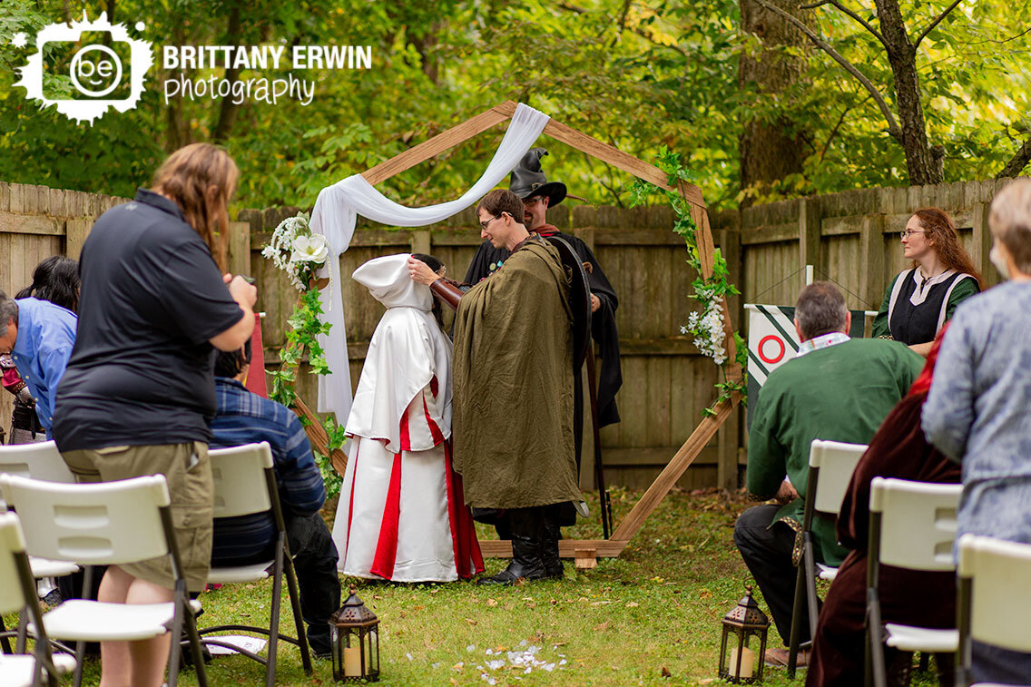 Indiana-wedding-ceremony-groom-at-altar-lowering-hood.jpg