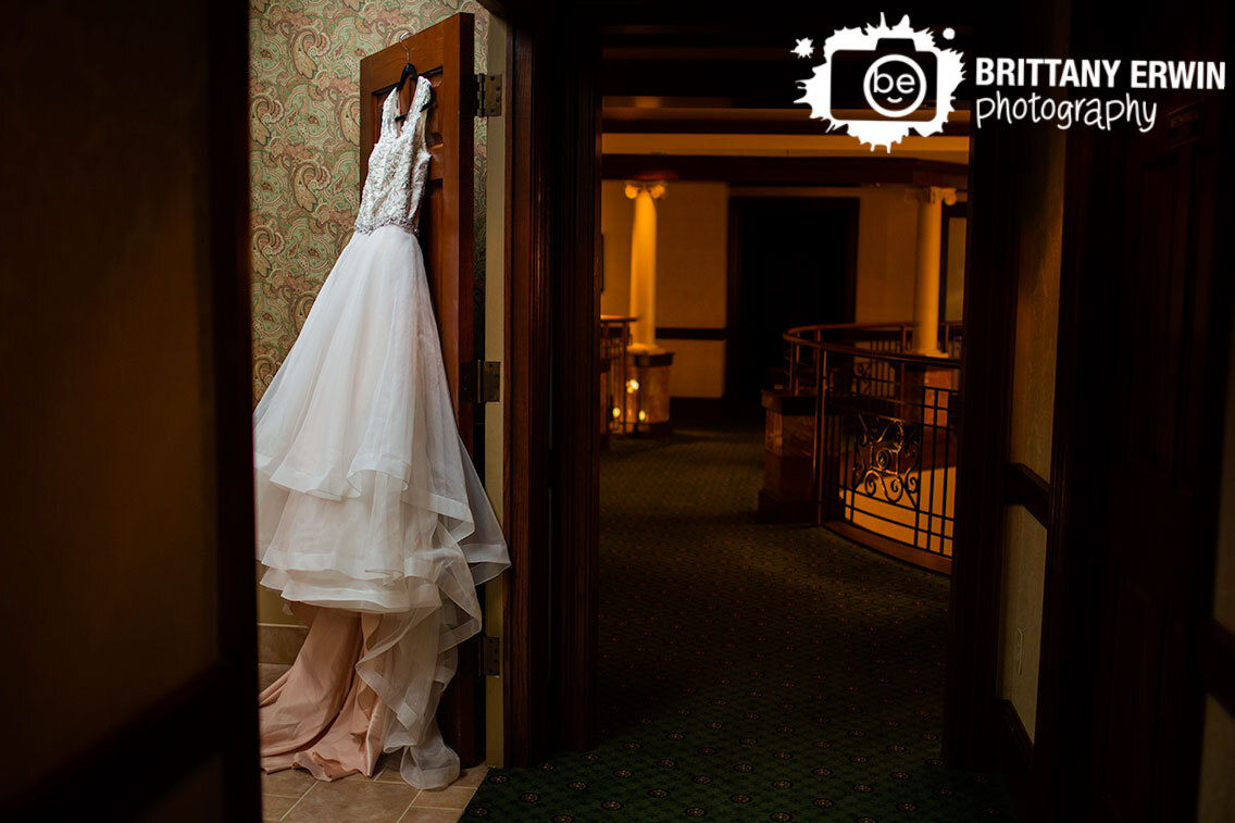 dress-hanging-on-door-detail-portrait-photographer-wedding-at-Community-Life-Center.jpg