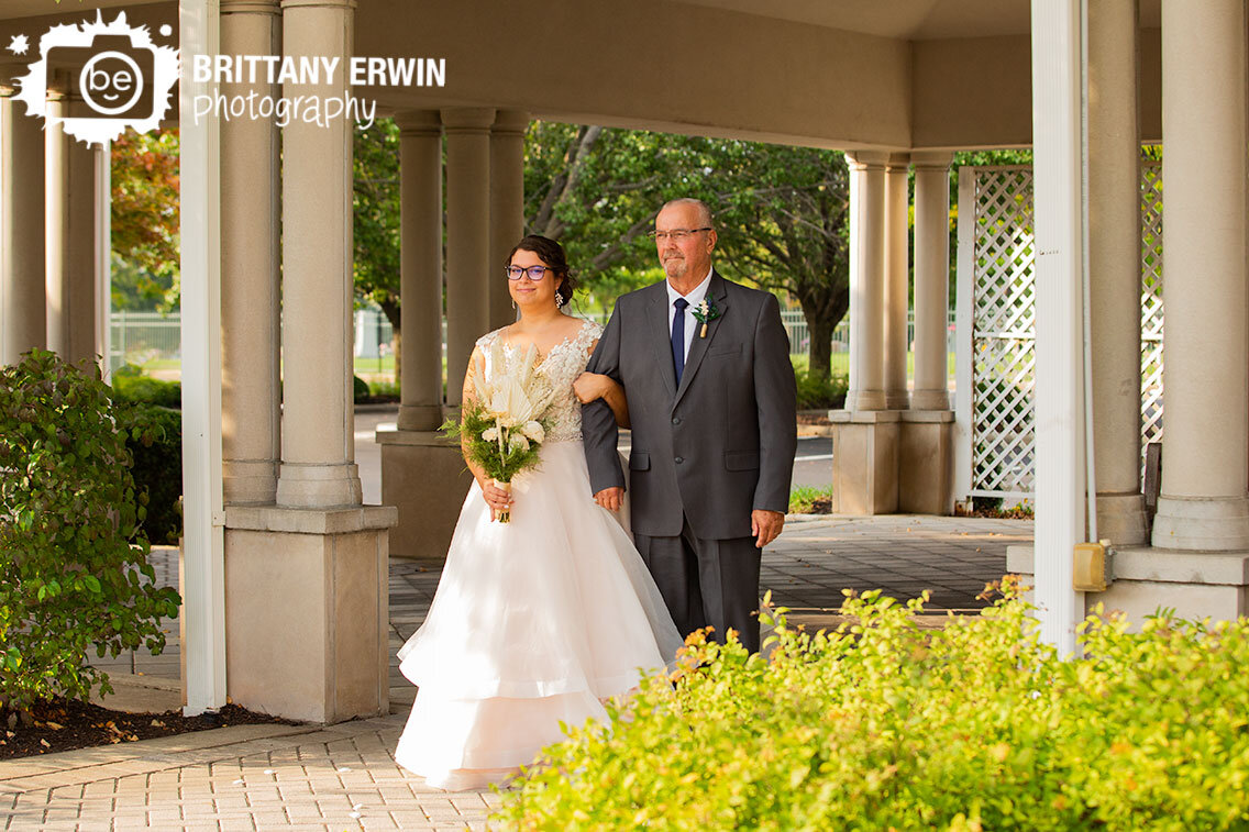 bride-walking-down-aisle-with-father-outdoor-wedding-ceremony.jpg