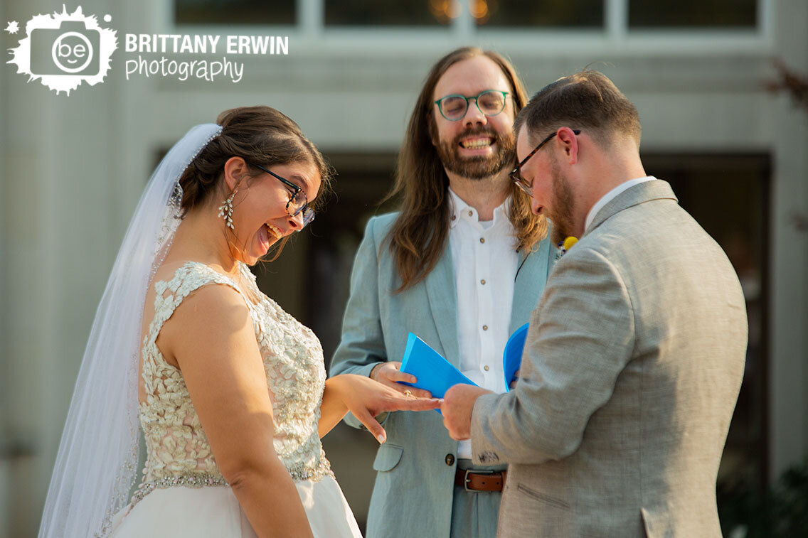 bride-laughing-at-wedding-ceremony-during-ring-exchange.jpg