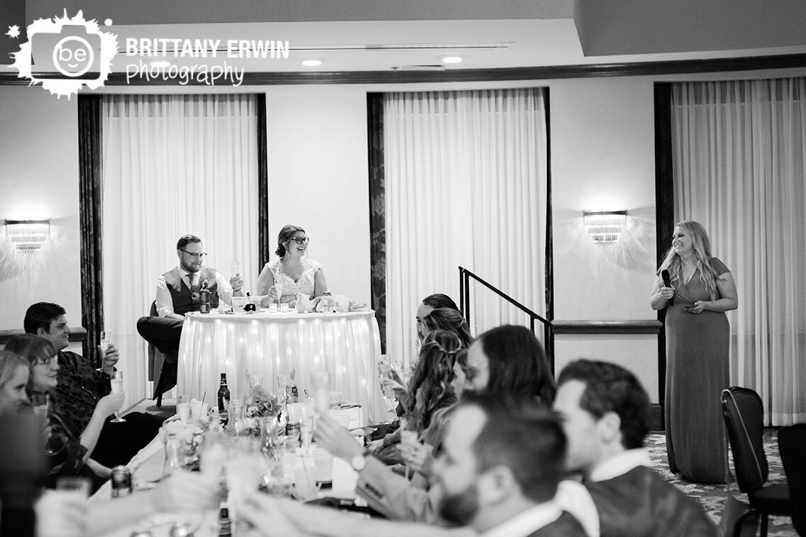 maid-of-honor-toast-at-wedding-reception-couple-at-sweetheart-table.jpg