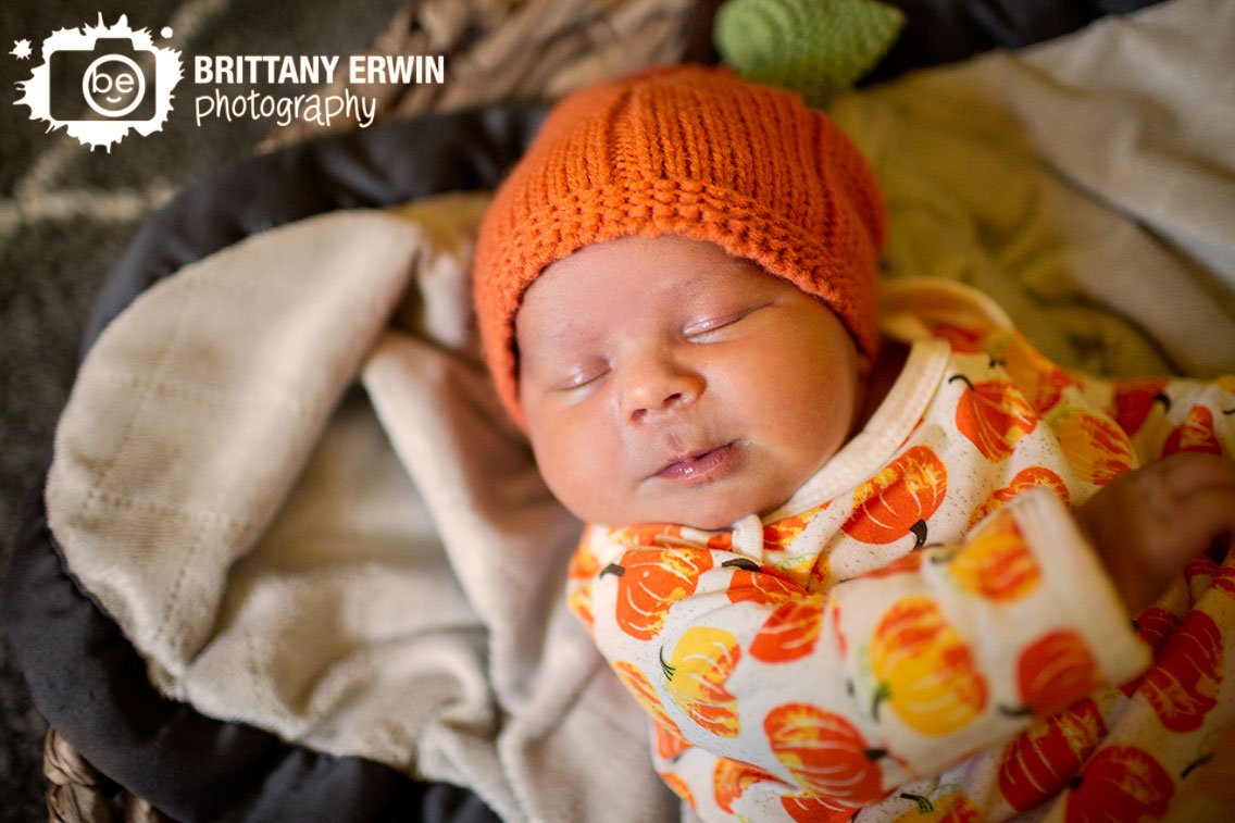 newborn-baby-boy-pumpkin-onesie-hat-fall-lifestyle-portrait.jpg