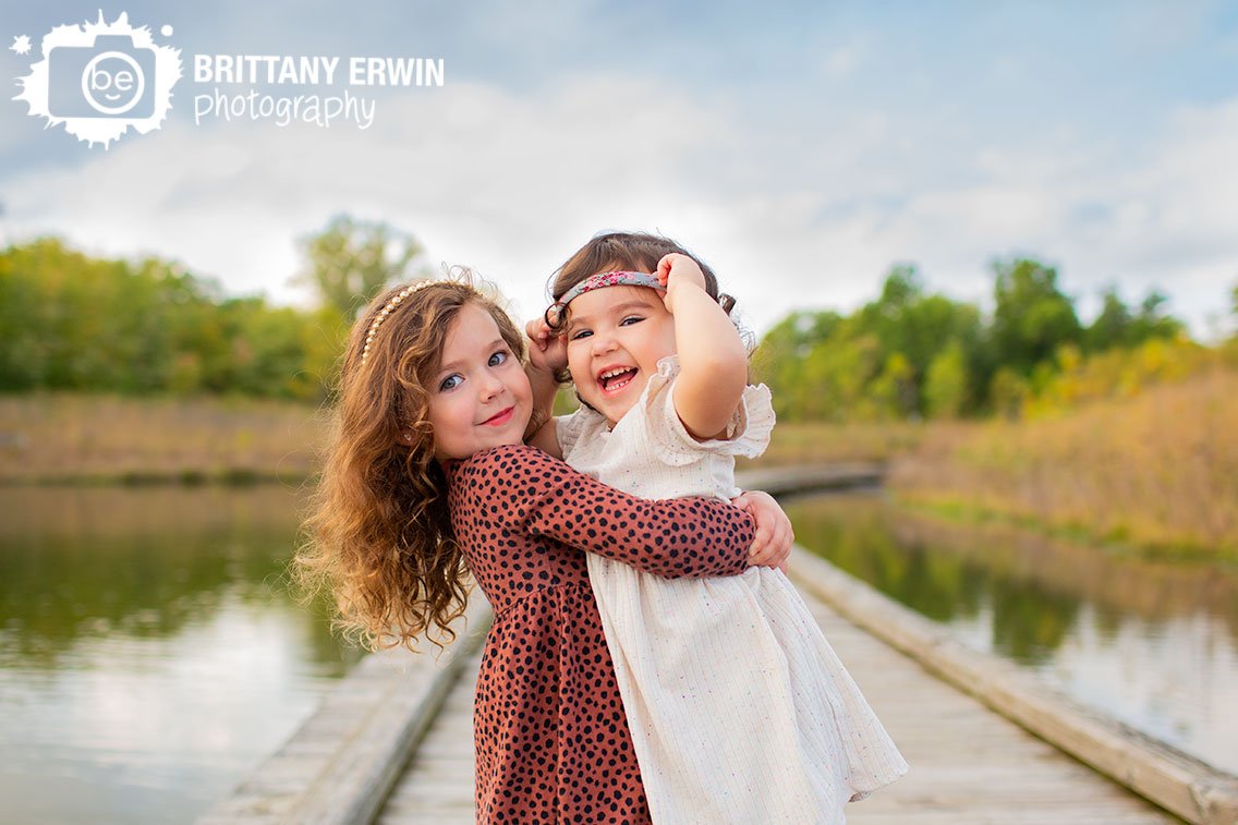 Indianapolis-siblings-fall-portrait-photographer-girls-laughing-on-boardwalk.jpg