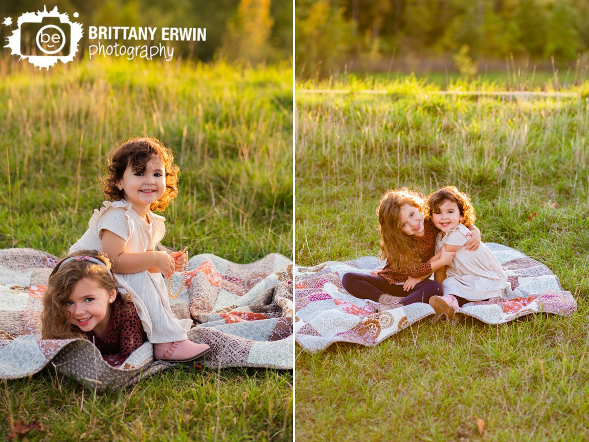 Indianapolis-fall-portrait-photographer-sisters-playing-on-quilt-in-tall-grass.jpg