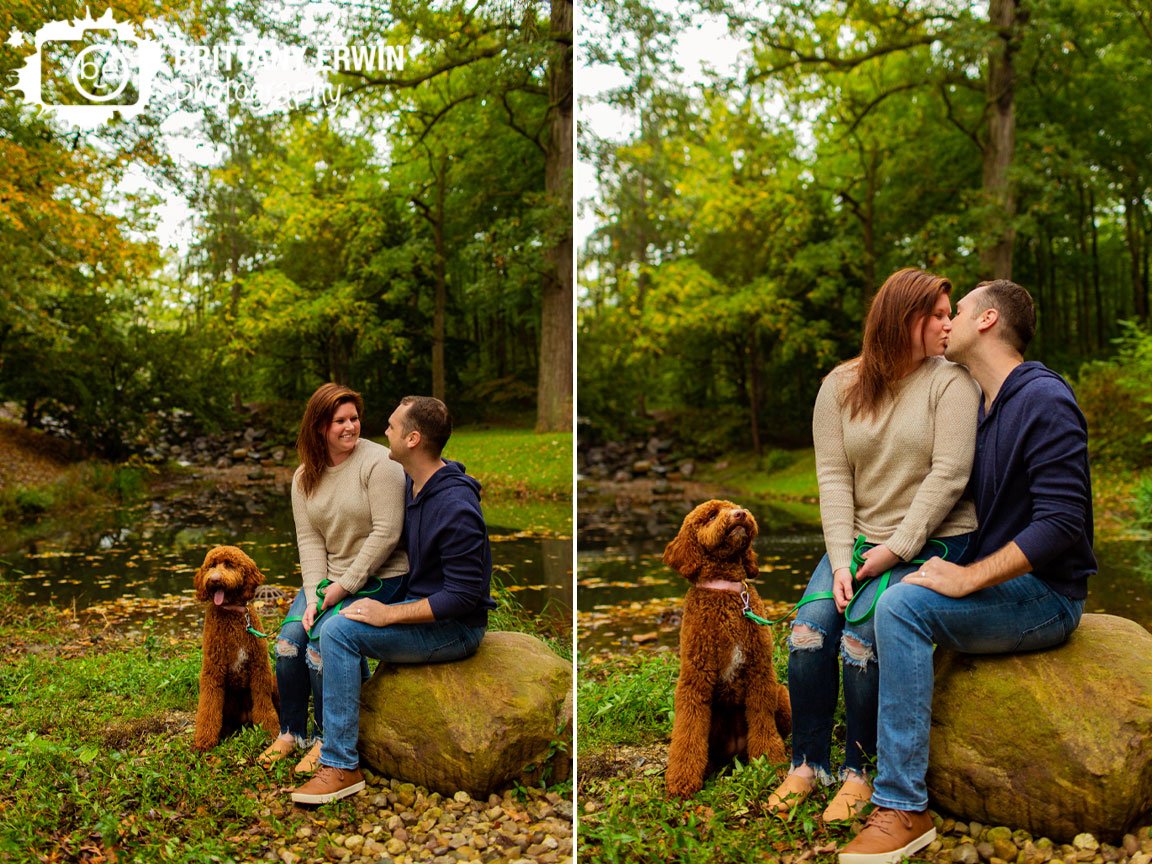 couple-holcomb-gardens-portrait-photographer-with-pet-dog-by-pond-sitting-on-rock.jpg
