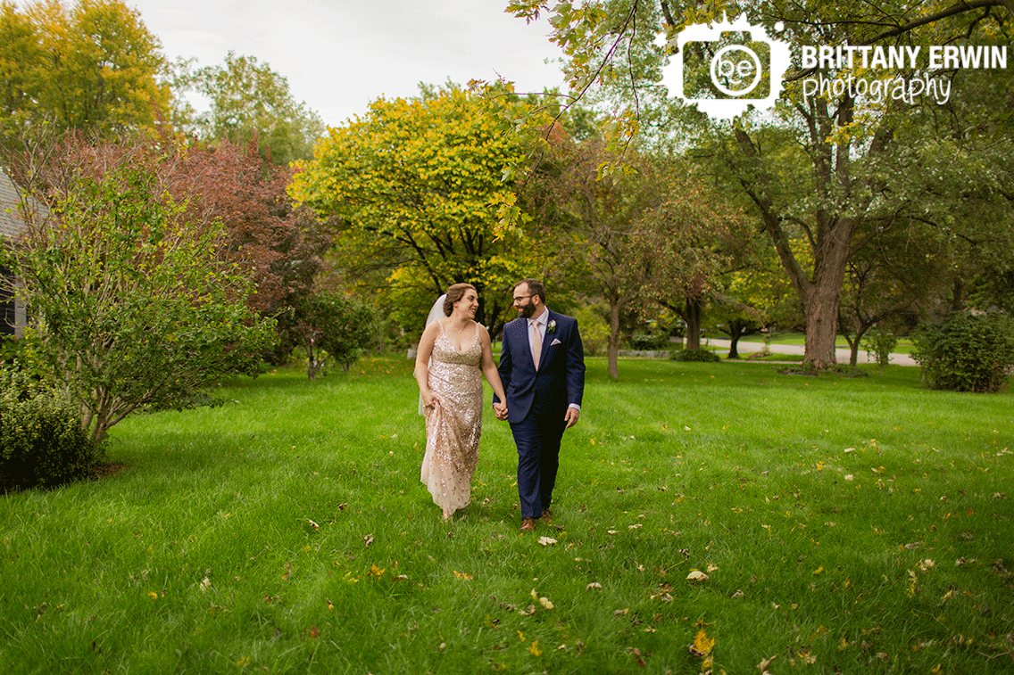 Indianapolis-wedding-photographer-couple-walking-through-yard-outside-portrait.gif