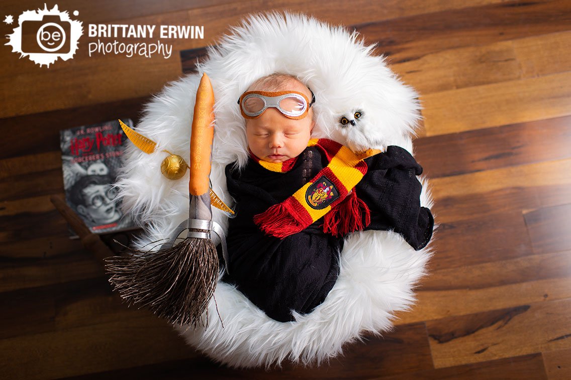 Harry-Potter-and-the-sorcerers-stone-book-newborn-portrait-photographer-black-wrap-with-broom-quidditch-goggles-snitch-and-wand.jpg