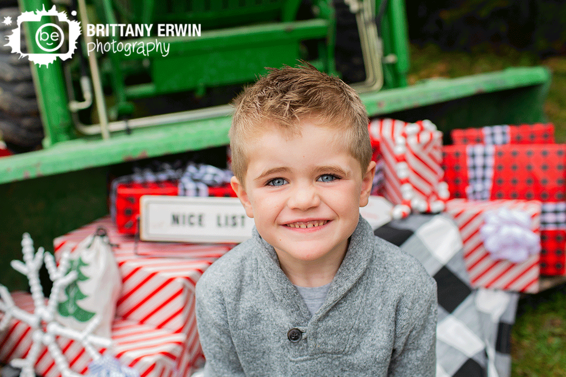 Indianapolis-portrait-photographer-Christmas-mini-session-boy-with-presents-wrapped.gif
