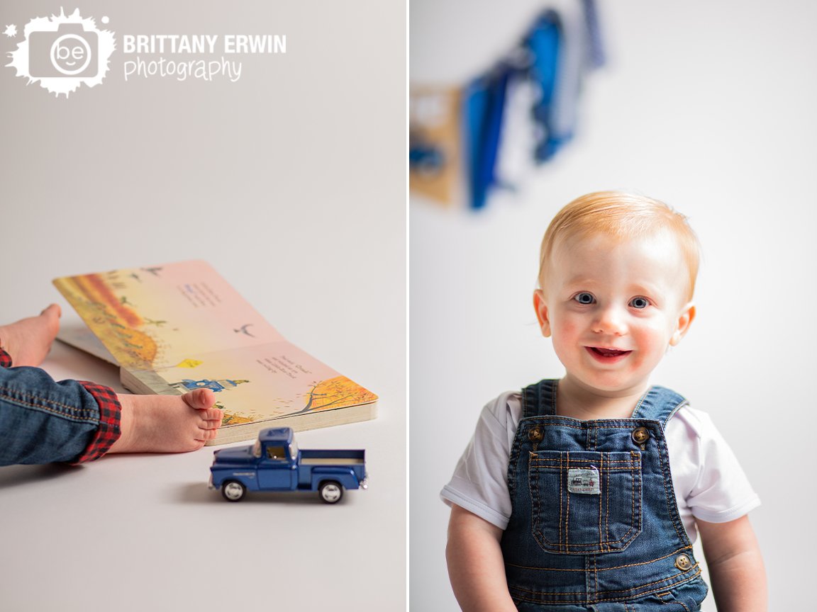 toddler-boy-first-birthday-session-book-with-little-blue-truck-toy-wearing-overalls.jpg