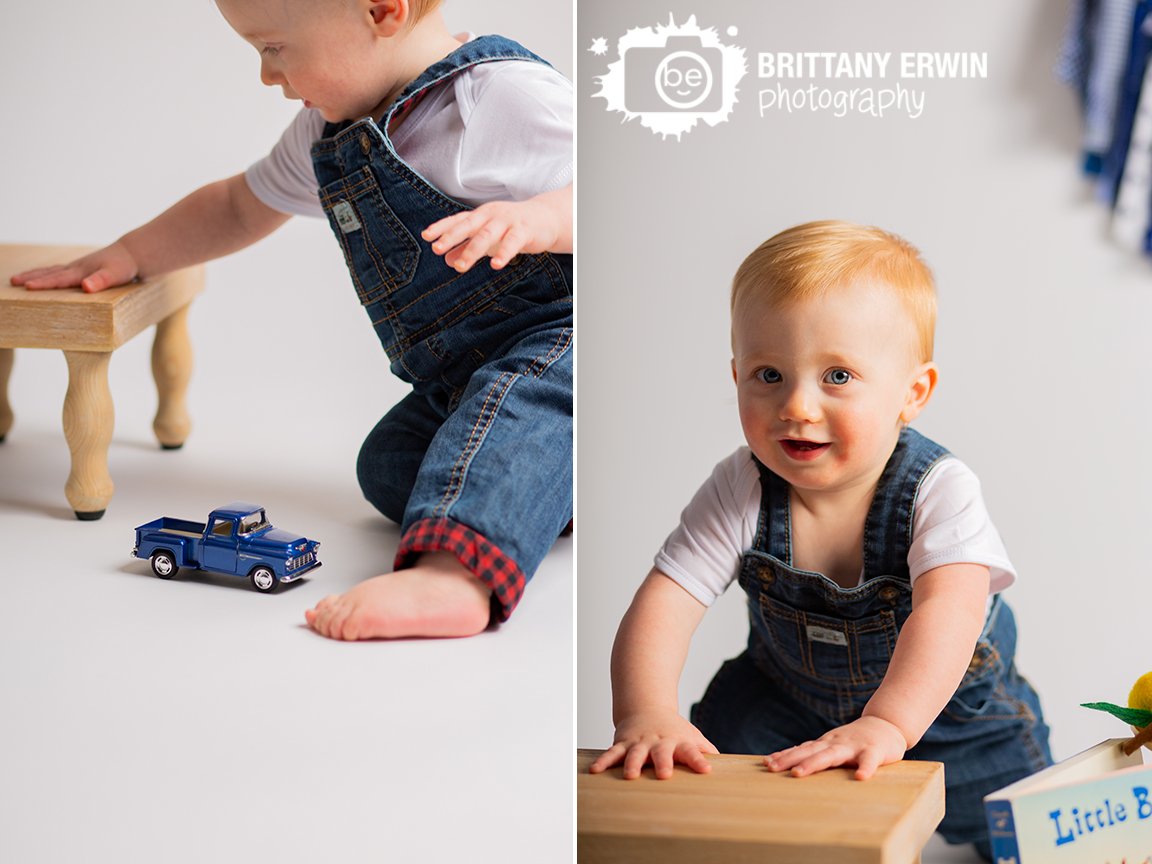 baby-boy-with-overalls-playing-with-little-blue-toy-truck.jpg