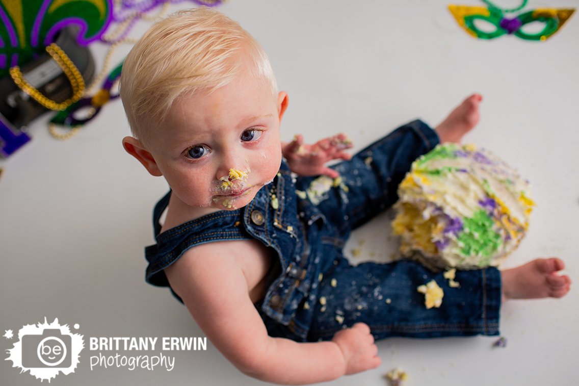 baby-boy-first-birthday-cake-smash-portrait-mardi-gras-overalls.jpg
